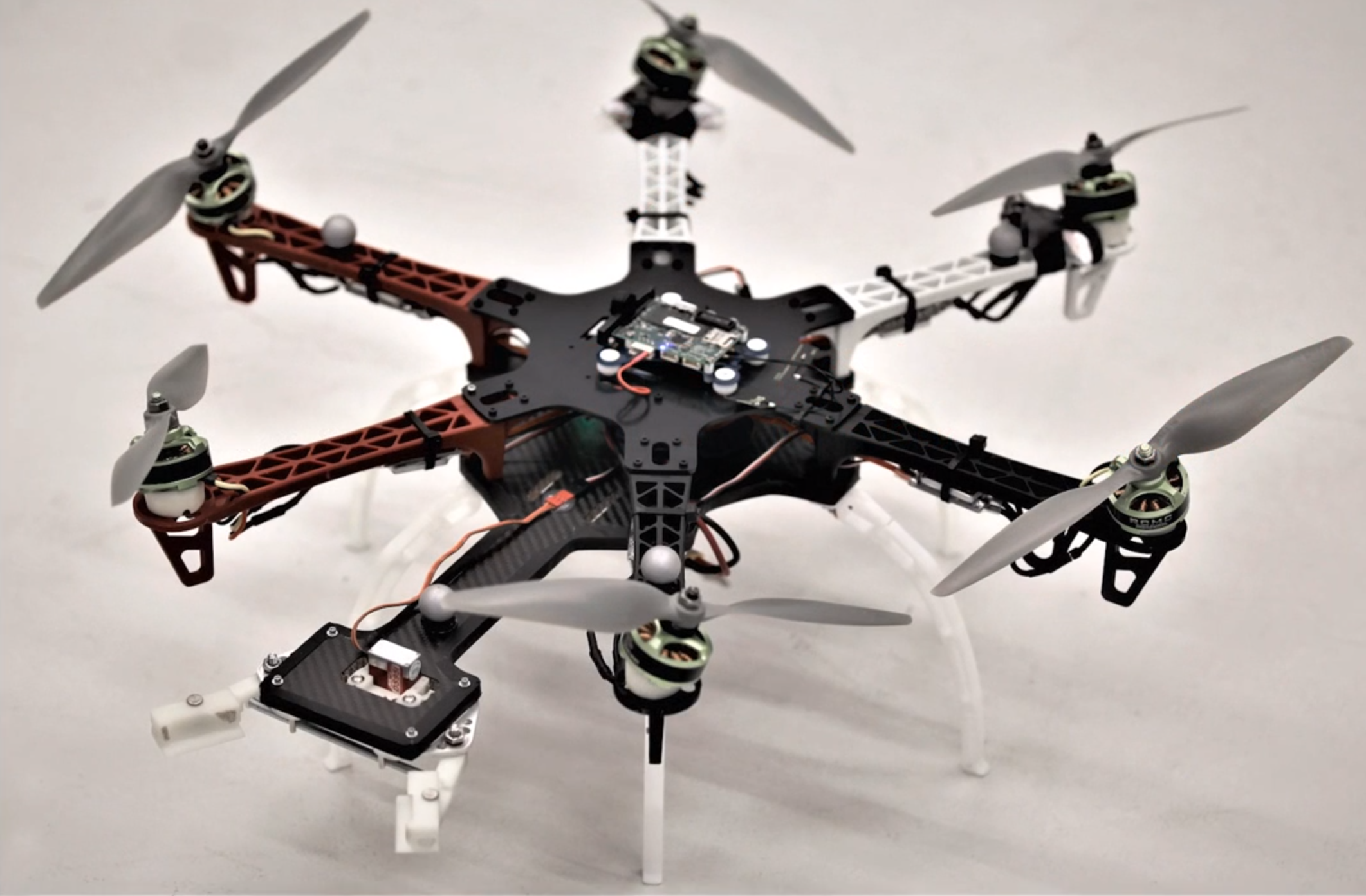 Agile Plate Transport with a Hexacopter with Canted Motors